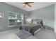 Relaxing bedroom with a comfortable bed, soft lighting and large window at 11497 Sw 82Nd Court Rd, Ocala, FL 34481