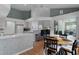 Bright breakfast nook featuring a round table, views into the living room, and lots of natural light at 11497 Sw 82Nd Court Rd, Ocala, FL 34481