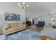 Bright living room featuring vaulted ceilings, modern lighting, and stylish decor at 11497 Sw 82Nd Court Rd, Ocala, FL 34481