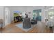 Open-concept living room with high ceilings, modern furnishings, and wood-look flooring at 11497 Sw 82Nd Court Rd, Ocala, FL 34481