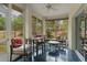 Cozy sunroom featuring tiled floors, comfortable seating and multiple large windows at 11497 Sw 82Nd Court Rd, Ocala, FL 34481