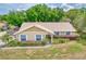 A bird's eye view of a well-maintained home with tidy landscaping and neutral color scheme at 11763 Oswalt Rd, Clermont, FL 34711