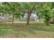 Over sized backyard enclosed by wooden fencing and mature trees with access to screened lanai at 11763 Oswalt Rd, Clermont, FL 34711