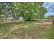 Large backyard enclosed by wooden fencing and mature trees at 11763 Oswalt Rd, Clermont, FL 34711