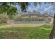 Expansive backyard featuring a screened lanai and lush landscaping, perfect for outdoor living at 11763 Oswalt Rd, Clermont, FL 34711