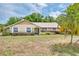Charming single-story home with a well-manicured lawn and mature landscaping at 11763 Oswalt Rd, Clermont, FL 34711