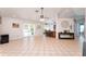 An open concept living space with light tile flooring leading to the backyard pool at 11763 Oswalt Rd, Clermont, FL 34711