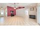 Spacious living room with a tile floor, TV, and access to other areas at 11763 Oswalt Rd, Clermont, FL 34711