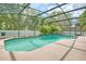 Inviting screened-in pool with lush landscaping and a spacious patio area at 11763 Oswalt Rd, Clermont, FL 34711