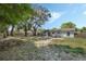 Spacious backyard featuring mature trees and a fenced perimeter, offering a private outdoor space at 11987 Se 95Th Ter, Belleview, FL 34420