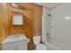 Full bathroom featuring light wood-look walls, a white vanity, toilet, and bathtub with shower at 11987 Se 95Th Ter, Belleview, FL 34420