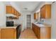 Functional kitchen featuring wood cabinets, essential appliances, and ample counter space at 11987 Se 95Th Ter, Belleview, FL 34420