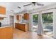 Functional kitchen with wood cabinets, access to backyard, and essential appliances at 11987 Se 95Th Ter, Belleview, FL 34420