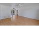 Bright living room with light hardwood floors, two ceiling fans, and sliding glass doors at 11987 Se 95Th Ter, Belleview, FL 34420