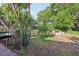 Backyard featuring a screened pool, a green lawn, trees, and patio furniture at 1202 Bly Ct, Eustis, FL 32726