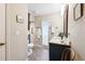 Well-lit bathroom with a vanity, toilet, and towel rack for convenience at 1202 Bly Ct, Eustis, FL 32726