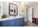 Charming bathroom featuring a vanity, mirror, and a bright open doorway at 1202 Bly Ct, Eustis, FL 32726