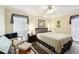 Inviting bedroom features a comfortable bed, ceiling fan, and bright windows at 1202 Bly Ct, Eustis, FL 32726
