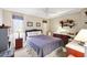 Serene bedroom with a bed, ceiling fan, and workspace with natural light at 1202 Bly Ct, Eustis, FL 32726
