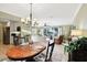 Open concept dining area with a view of the living room and outdoor landscape at 1202 Bly Ct, Eustis, FL 32726