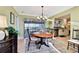 Elegant dining room featuring a chandelier, table setting, and view of the outdoor patio at 1202 Bly Ct, Eustis, FL 32726