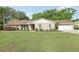 Charming single-story home with a well-manicured lawn and inviting curb appeal on a sunny day at 1202 Bly Ct, Eustis, FL 32726