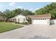 Exterior view of a home showing a large two car garage and spacious driveway at 1202 Bly Ct, Eustis, FL 32726