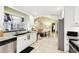 Bright, open kitchen flows into the living area with stainless steel appliances at 1202 Bly Ct, Eustis, FL 32726