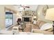 Cozy living room with a stone fireplace, built-in shelves, and sliding door leading to the pool at 1202 Bly Ct, Eustis, FL 32726