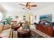 Comfortable living room with a ceiling fan, ample seating, and bright natural light at 1202 Bly Ct, Eustis, FL 32726