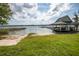 Lakeside view with a sandy beach, boat dock, and picnic pavilion at 1202 Bly Ct, Eustis, FL 32726