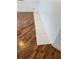 Close-up of new baseboard trim against wood-look flooring and a freshly painted white wall at 121 Maple Dr, Debary, FL 32713