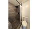 Modern renovated bathroom featuring a tiled walk-in shower, a toilet, and tiled flooring at 121 Maple Dr, Debary, FL 32713