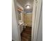 Compact bathroom featuring a vanity, toilet, and shower-tub combination with updated flooring at 121 Maple Dr, Debary, FL 32713
