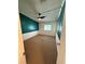 Cozy bedroom with carpet, half-painted walls, ceiling fan, and a window providing natural light at 121 Maple Dr, Debary, FL 32713