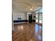 Bright living room featuring wood-look floors, natural light from large windows, and a ceiling fan at 121 Maple Dr, Debary, FL 32713