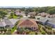 Aerial view of a house showcasing the roof, backyard, and surrounding neighborhood at 1210 Weaton Ct, The Villages, FL 32162