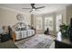 Comfortable bedroom featuring wood floors, a ceiling fan and plantation shutters at 1210 Weaton Ct, The Villages, FL 32162