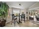 Bright breakfast nook featuring a table with two stools and sliding door access to the lanai at 1210 Weaton Ct, The Villages, FL 32162