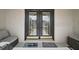 Inviting covered entry with double doors, accent seating, and welcome mats at 1210 Weaton Ct, The Villages, FL 32162