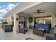 Outdoor patio area featuring comfortable furniture, a ceiling fan and view to the yard at 1210 Weaton Ct, The Villages, FL 32162