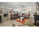 Spacious living room with wood floors, comfortable seating, and stylish decor at 1210 Weaton Ct, The Villages, FL 32162