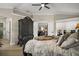 Main bedroom features a ceiling fan, wood floors, and a view into the adjacent living room at 1210 Weaton Ct, The Villages, FL 32162