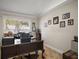 Office space with a large wood desk, a window and picture frames on the wall at 1210 Weaton Ct, The Villages, FL 32162