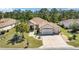 Inviting home with a well-manicured lawn, mature trees, and an extra wide driveway at 12511 Se 91St Terrace Rd, Summerfield, FL 34491