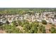Wide aerial shot of a residential community surrounded by mature trees and greenery at 12511 Se 91St Terrace Rd, Summerfield, FL 34491