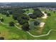 Aerial view of a lush golf course with ponds and walking paths at 12511 Se 91St Terrace Rd, Summerfield, FL 34491