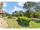 The backyard has lush greenery, manicured shrubs, and a tranquil setting with mature trees at 12511 Se 91St Terrace Rd, Summerfield, FL 34491