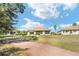 Charming home exterior showcasing a well-manicured lawn in a peaceful neighborhood at 12511 Se 91St Terrace Rd, Summerfield, FL 34491