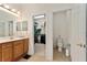 Bathroom featuring wood cabinets, walk-in closet, and private toilet area at 12511 Se 91St Terrace Rd, Summerfield, FL 34491